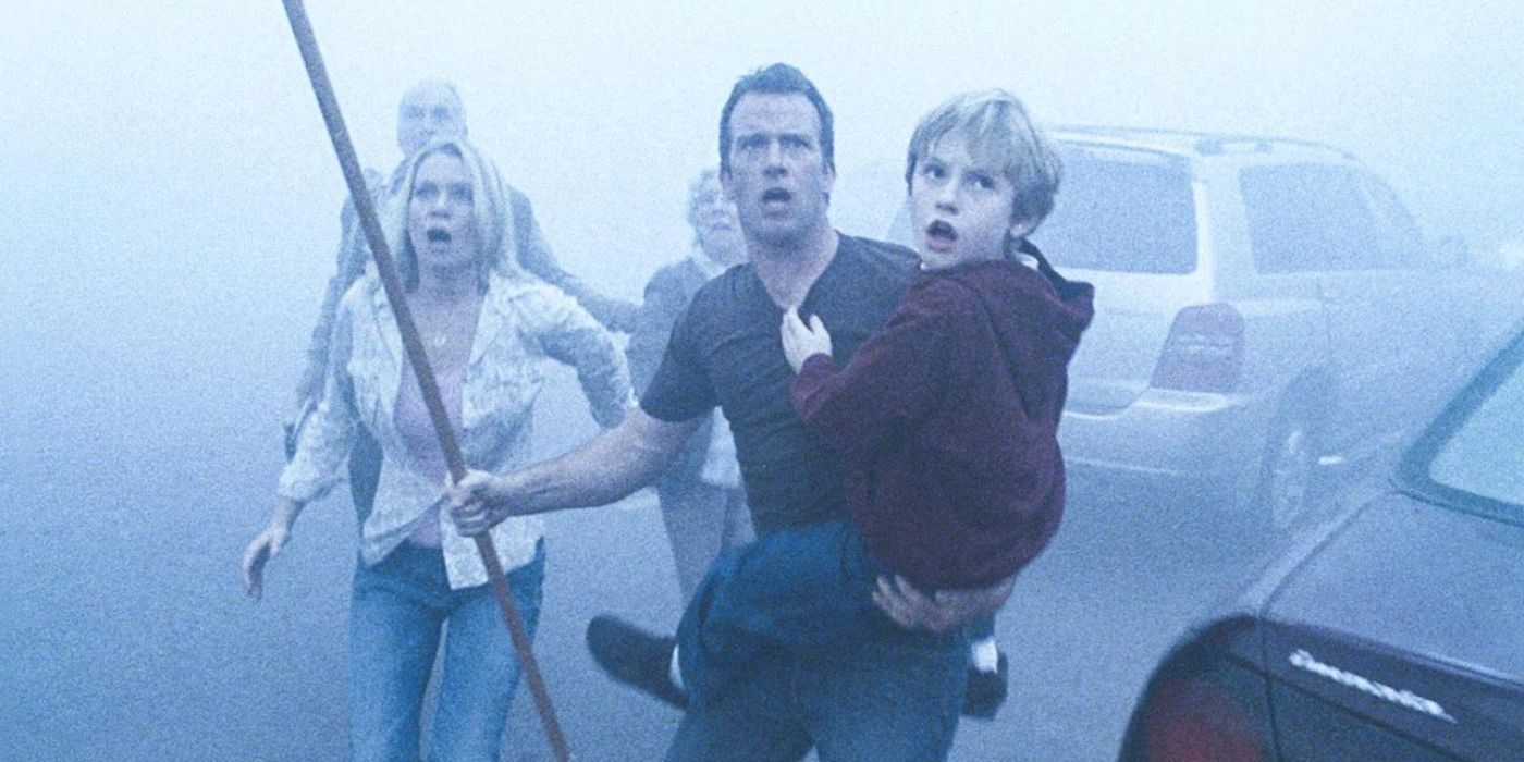Thomas Jane as David holding a stick and his son and protecting people in The Mist