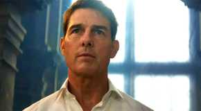 Tom Cruise as Ethan Hunt standing in front of the window in Mission Impossible Dead Reckoning Part One