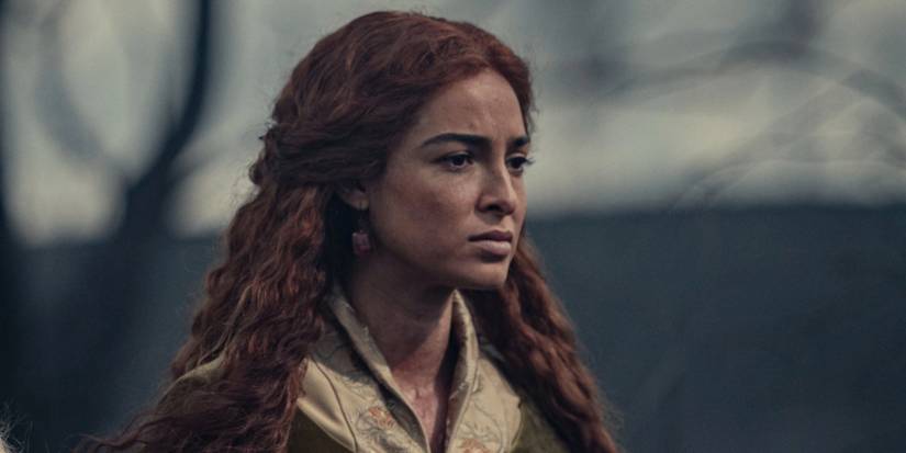 Triss looks off in the distance with concern on her face in The Witcher.