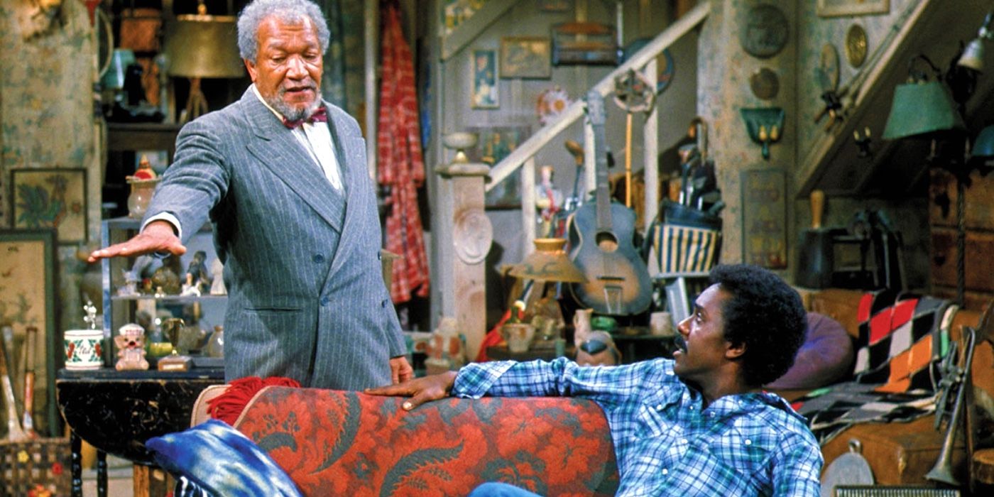 Mr. Sanford talking to his adult son in their living room full of odds and ends in Sanford and Son