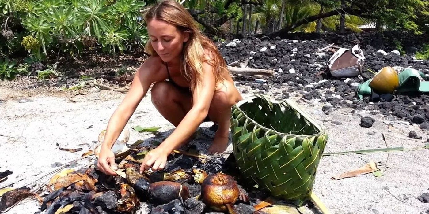 Alison on Naked and Afraid crouching with woven basket in sand