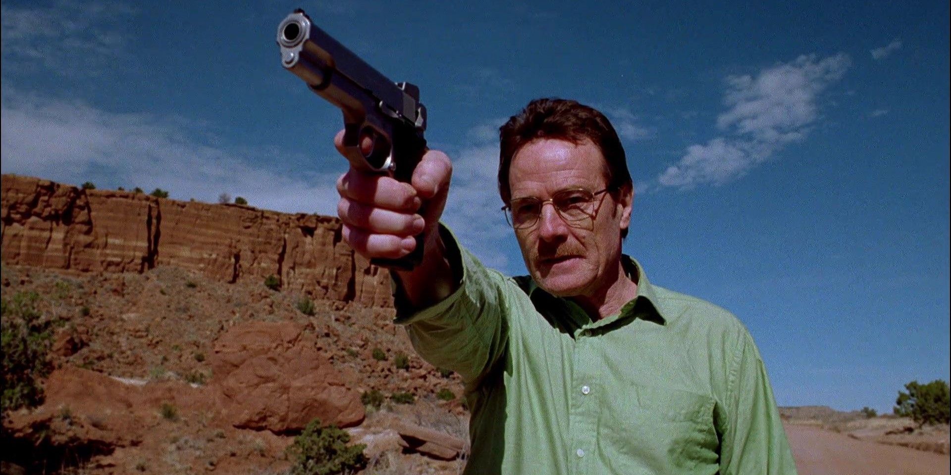 Walter White Wearing a Green Shirt and Holding a Gun in the Breaking Bad Pilot