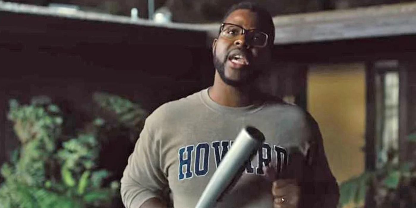 Winston Duke holding a baseball bat in Us