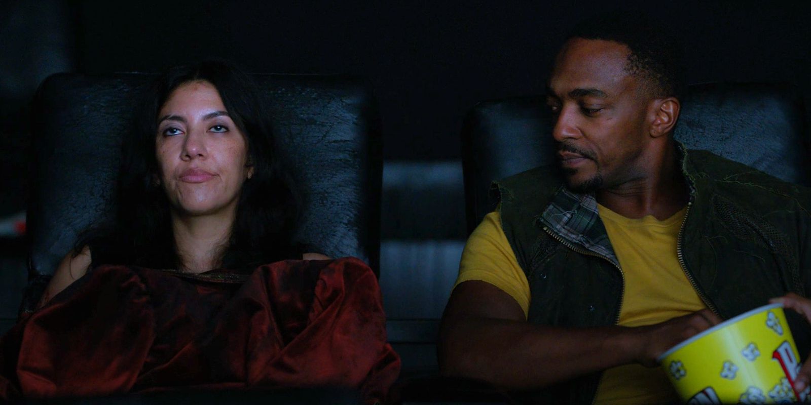 John Doe looks at Quiet while they&rsquo;re sitting in a movie theater.