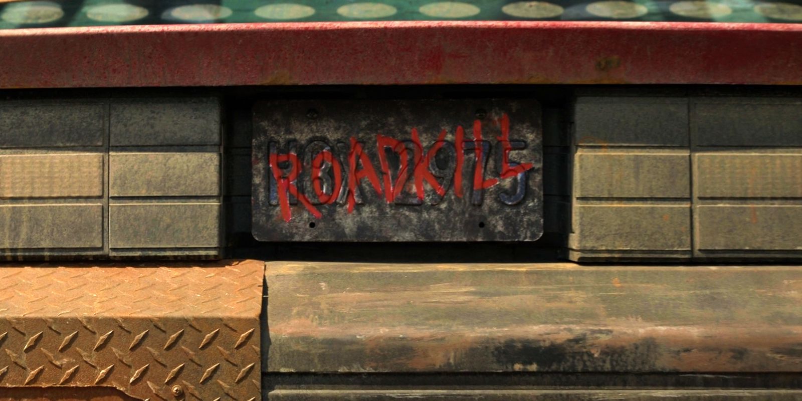 The name &ldquo;Roadkill&rdquo; is spraypainted over a license plate.