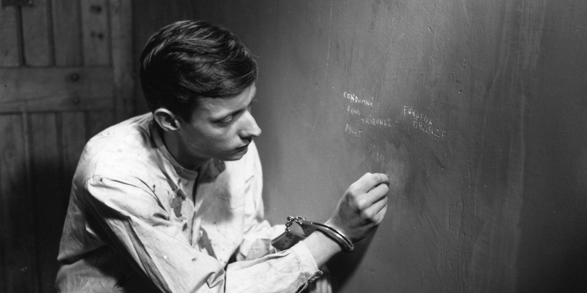 Prisoner writing on the wall in A Man Escaped (1956)