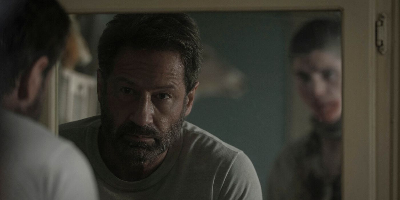 A man looking in the mirror in Pet Sematary: Bloodlines.