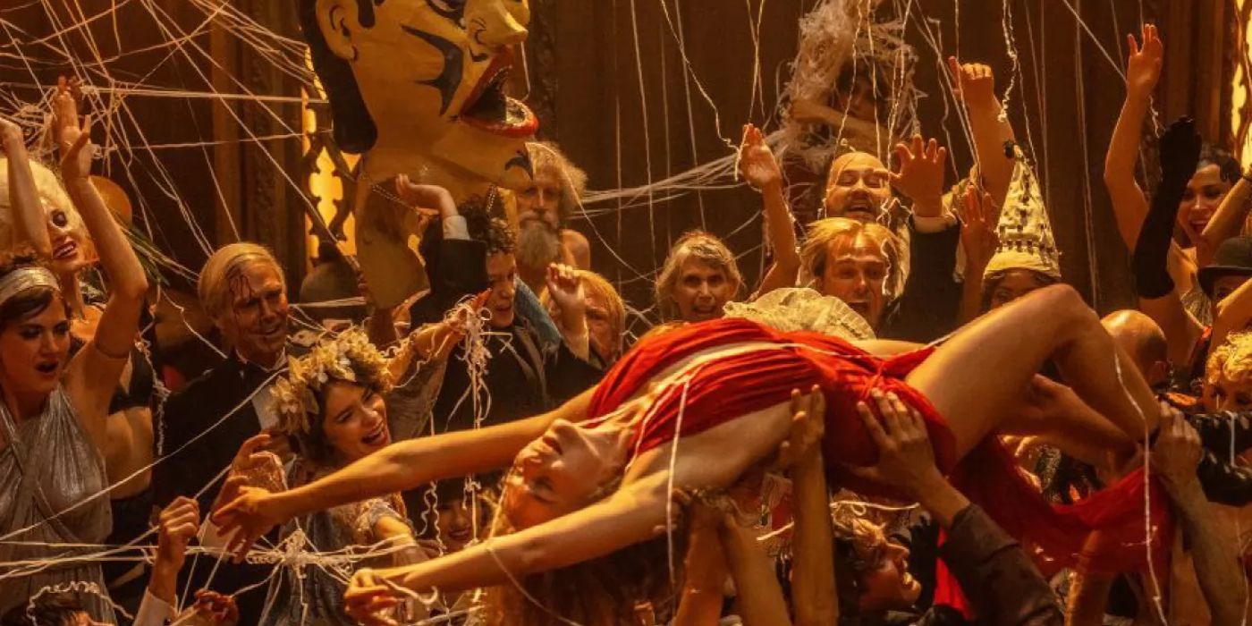 A woman body surfs through a raucous party in the movie Babylon.