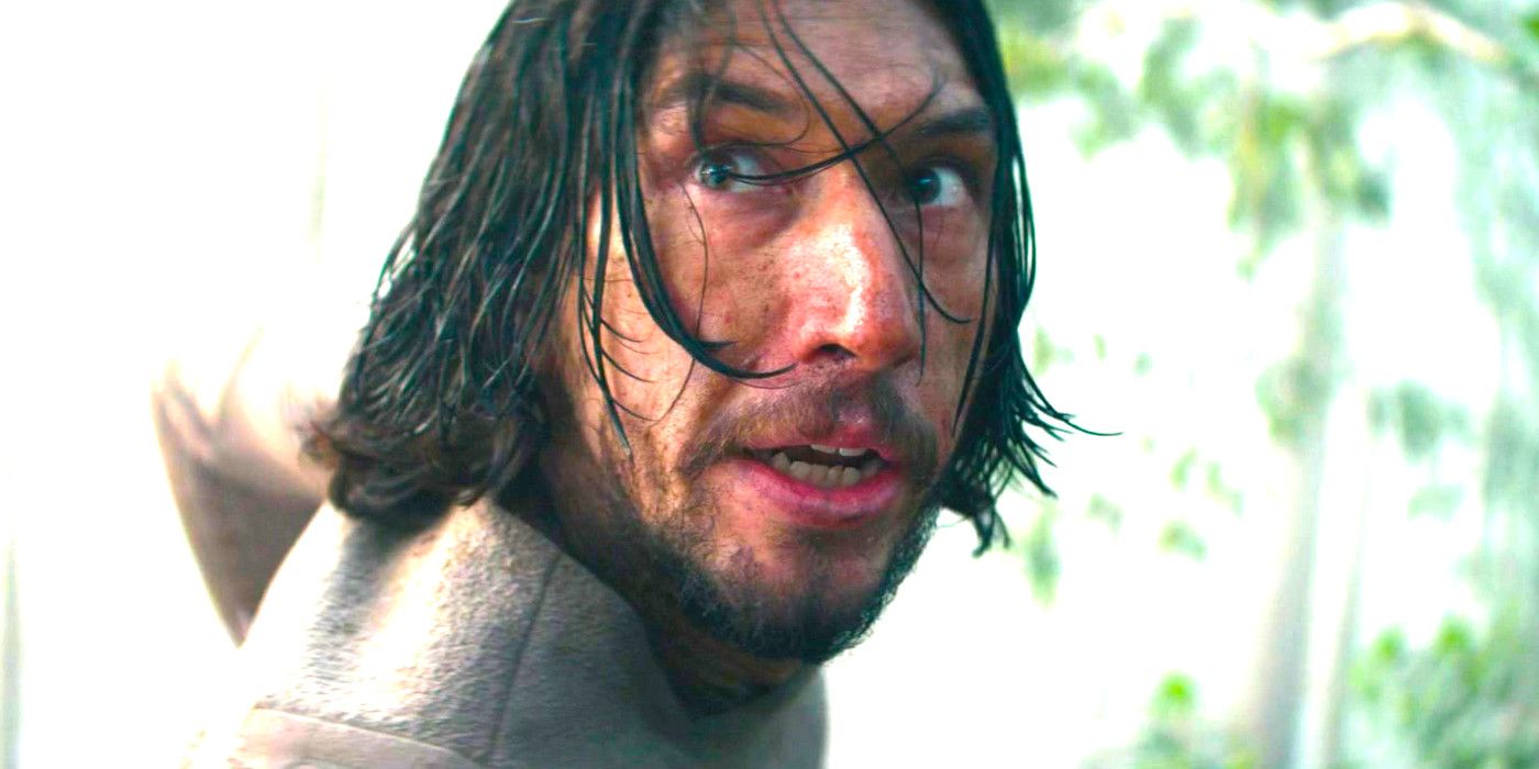 Adam Driver is wet and disheveled as he looks at something with wide eyes in the movie 65