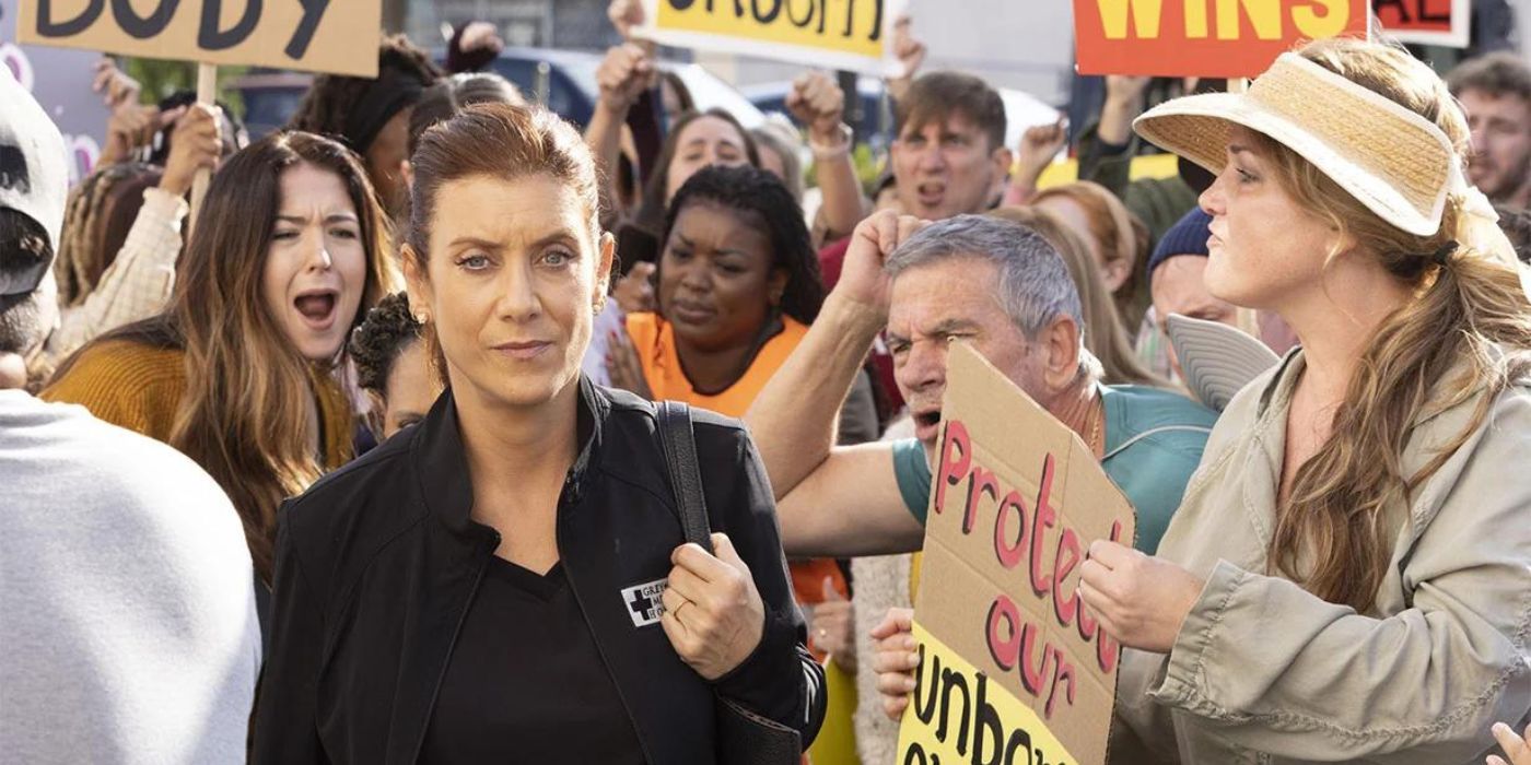 Addison Montgomery walks by anti-abortion protesters in Grey's Anatomy season 19