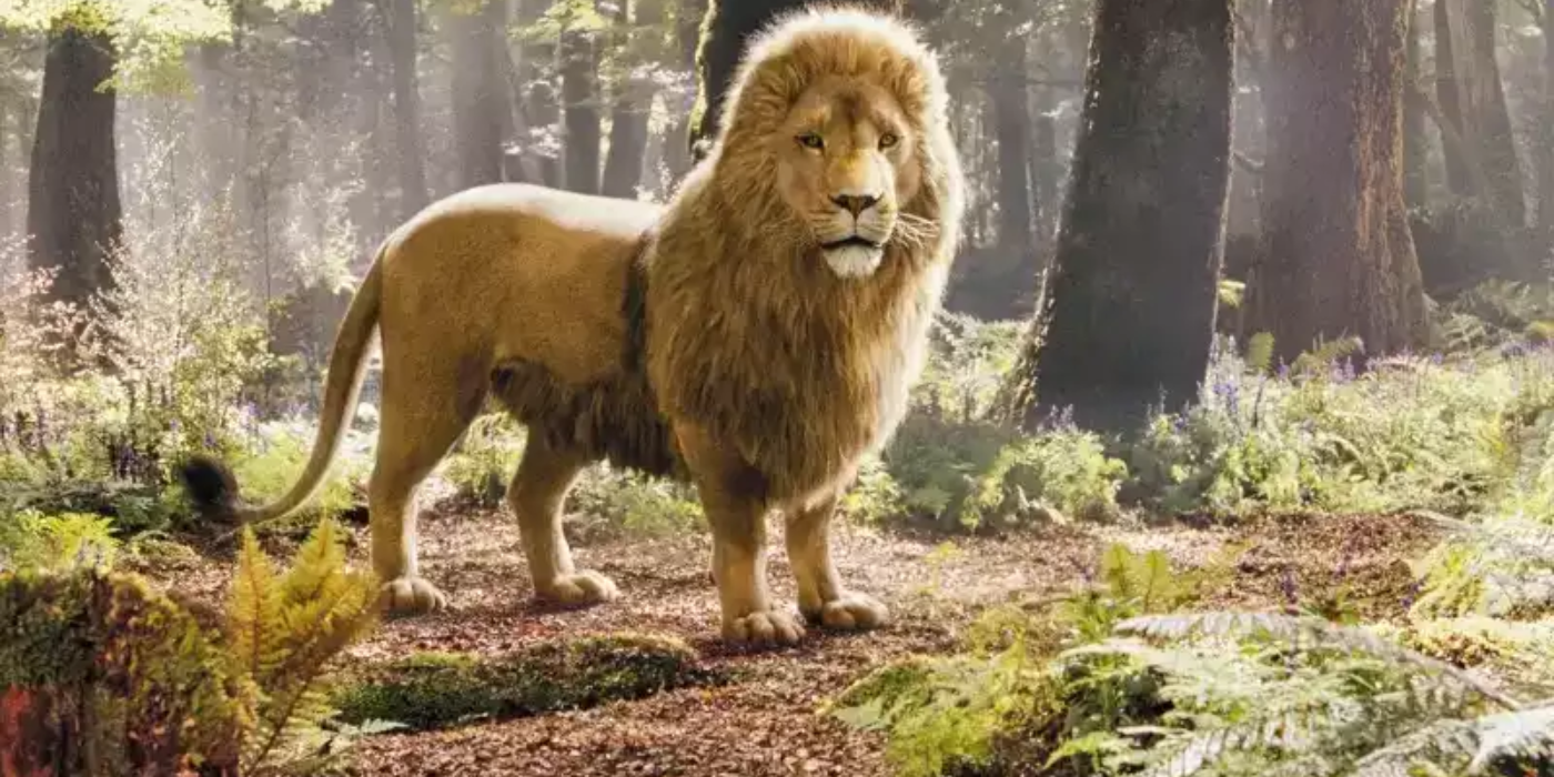 Aslan the lion standing in the woods in The Chronicles of Narnia