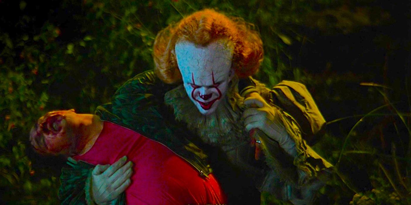 Bill Skarsgard as Pennywise Holding a Bloody Man By the Riverside in It Chapter Two