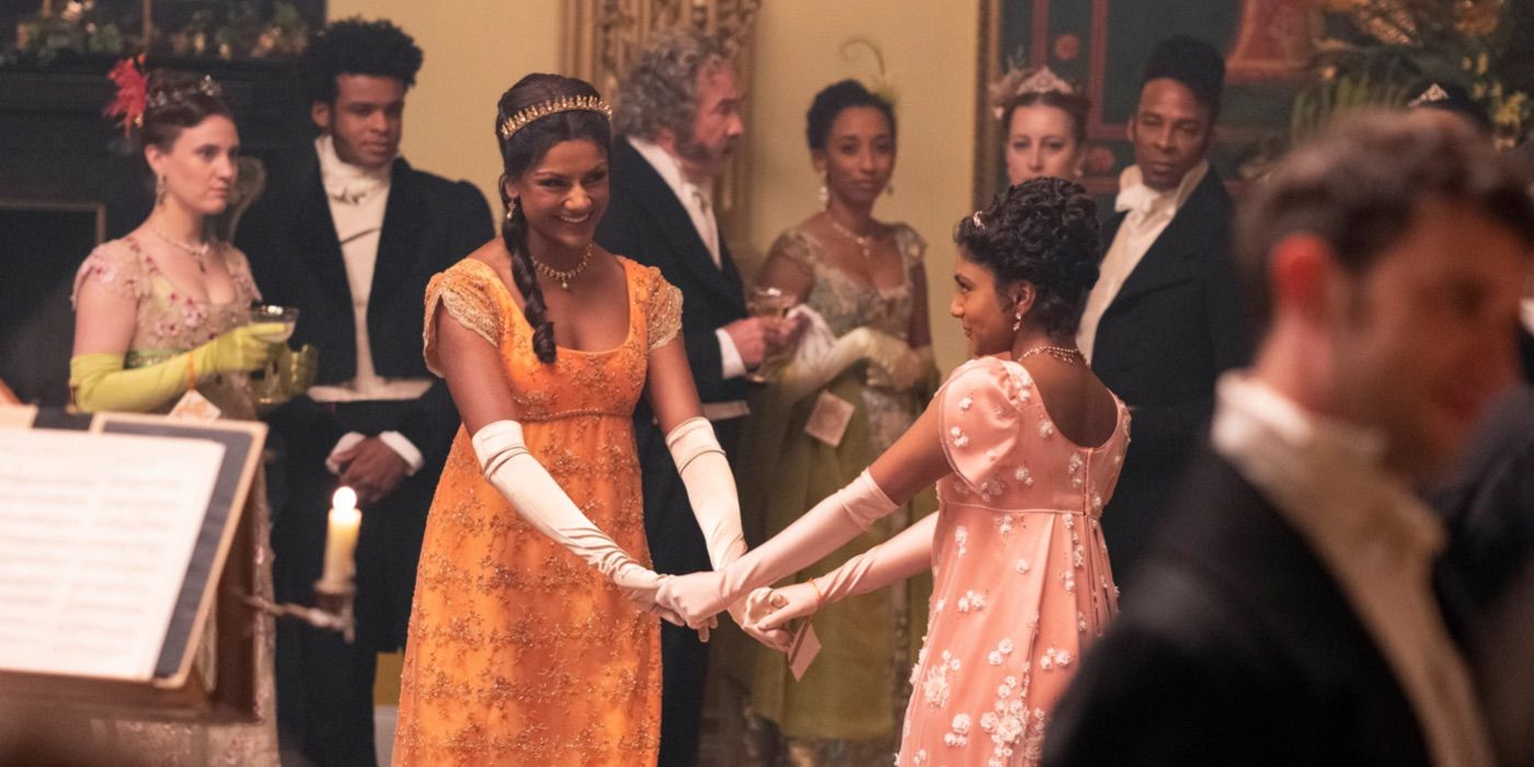 Kate dances in an orange dress in Bridgerton 