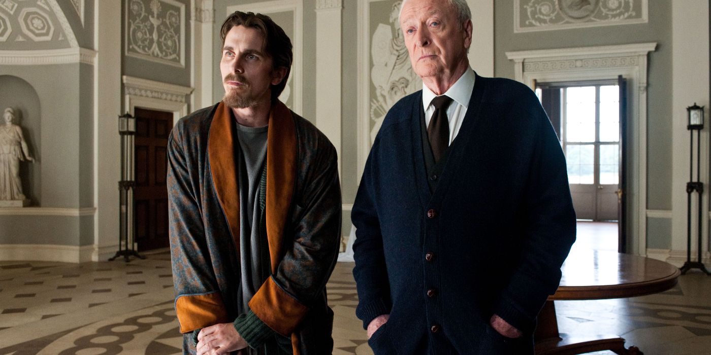 Christian Bale as retired Bruce Wayne standing with Michael Caine as Alfred in The Dark Knight Rises (2012)