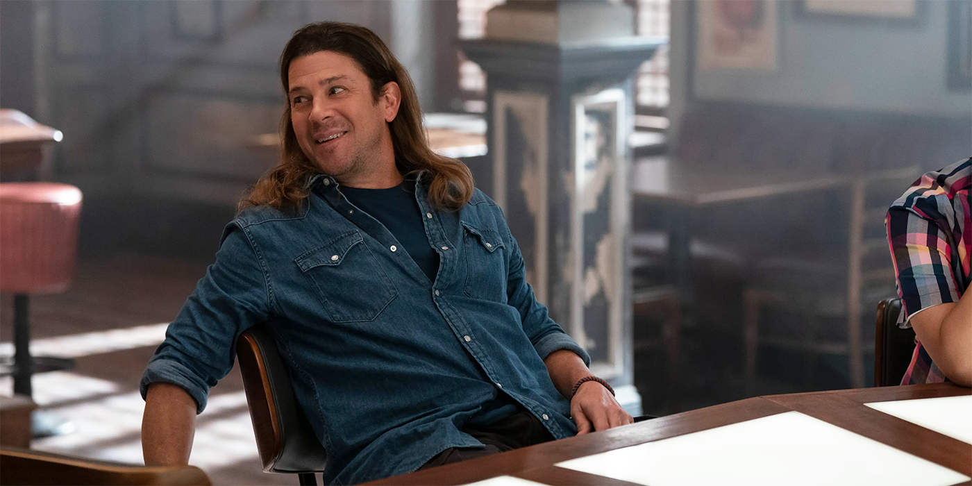 Christian Kane leaning back in a chair in Leverage Redemption