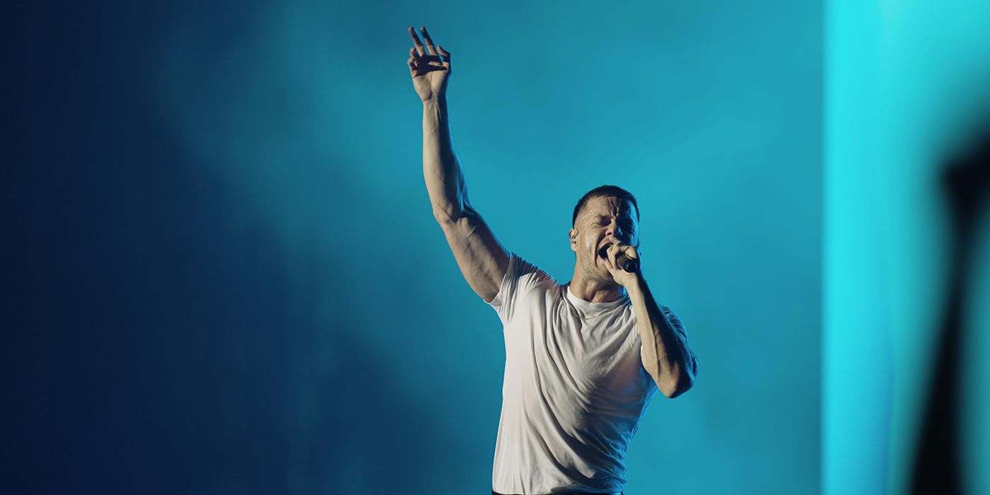 dan with arm up during natural at imagine dragons concert