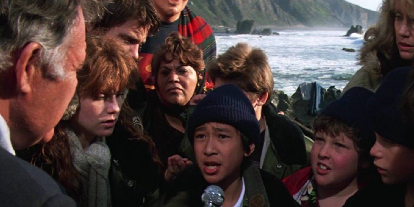 Data talking with reporters in The Goonies