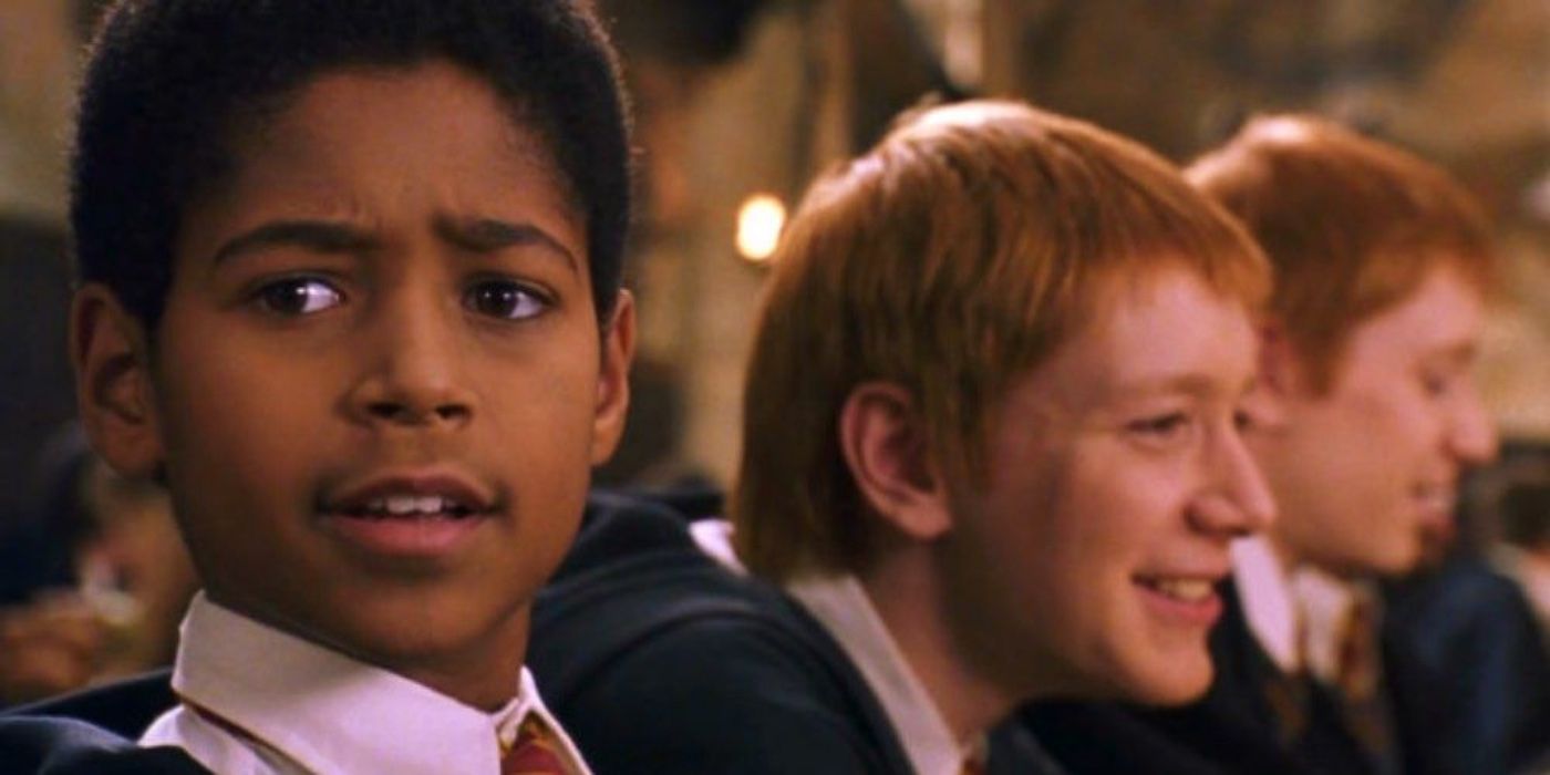 Dean Thomas sitting next to Fred and George in the Great Hall in Harry Potter