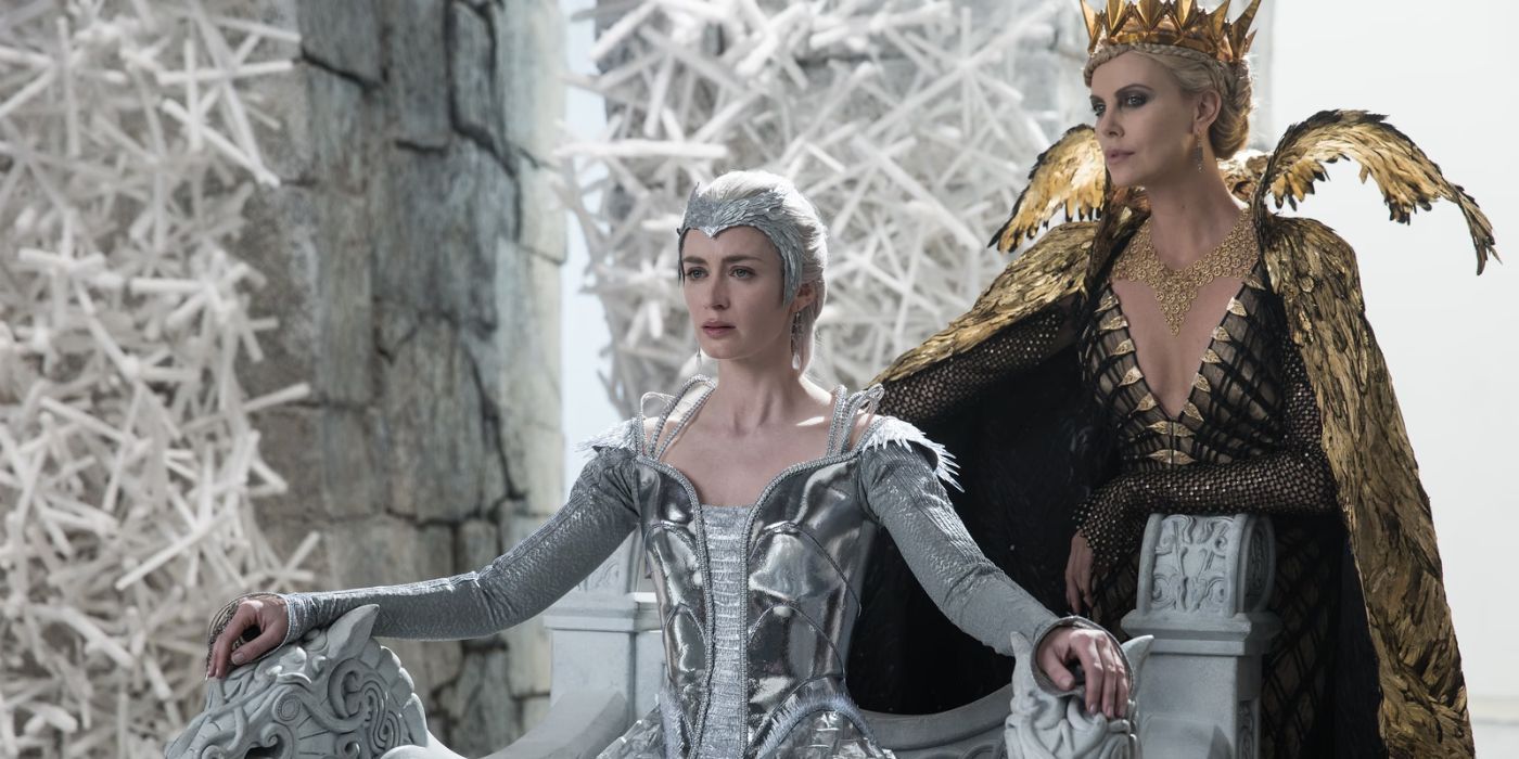 Emily Blunt sitting on a throne while Charlize Theron stands next to her in The Huntsman Winter's War