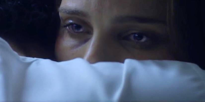 Lena looks over a shoulder with shimmering eyes in Annihilation.