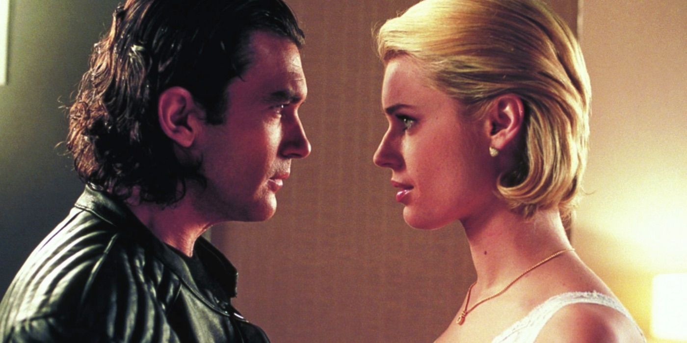Rebecca Romijn and Antonio Banderas talk closely in Femme Fatale 2002