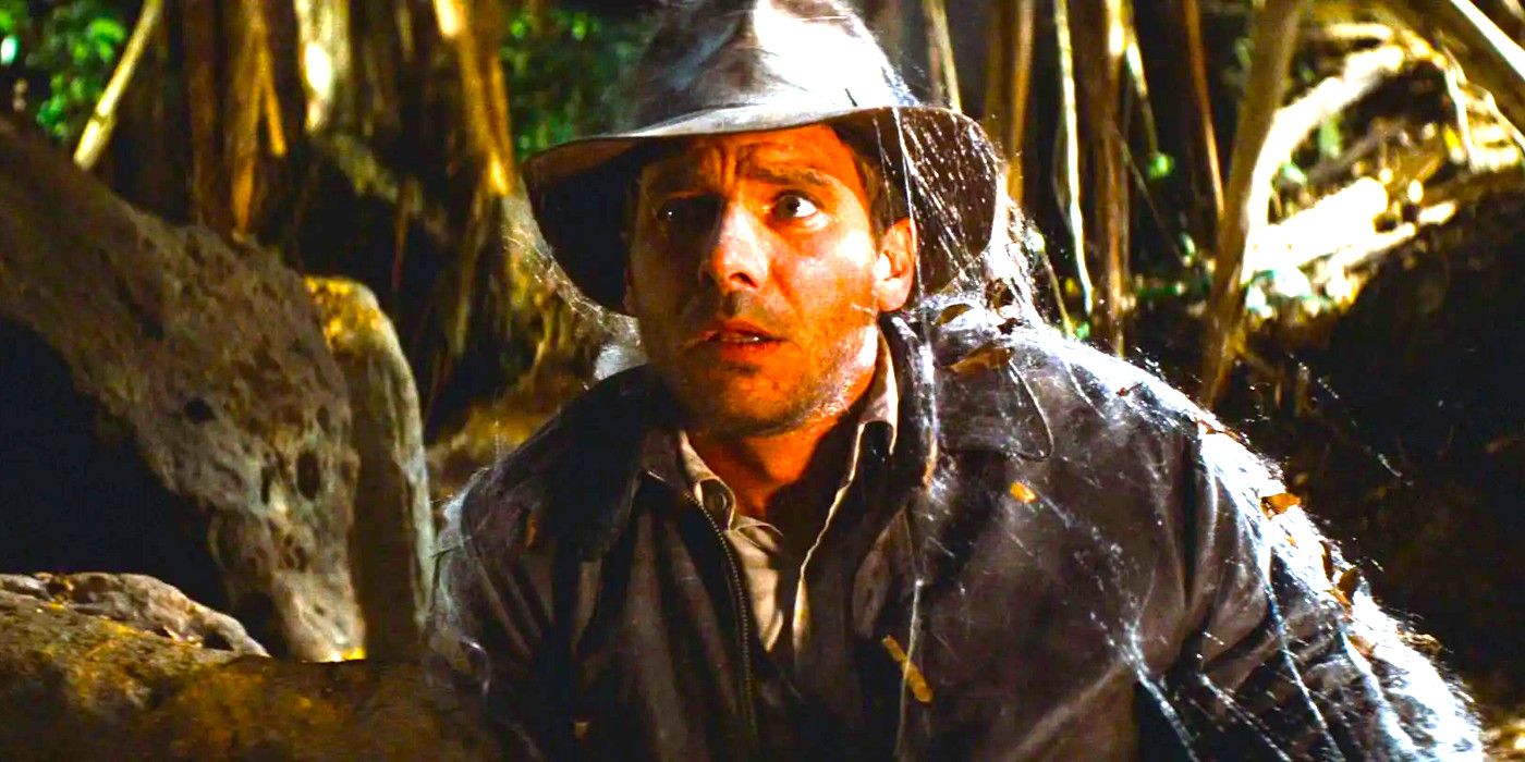 Harrison Ford as Indiana Jones in Raiders of the Lost Ark in the jungle covered in cobwebs having just escaped from a tomb