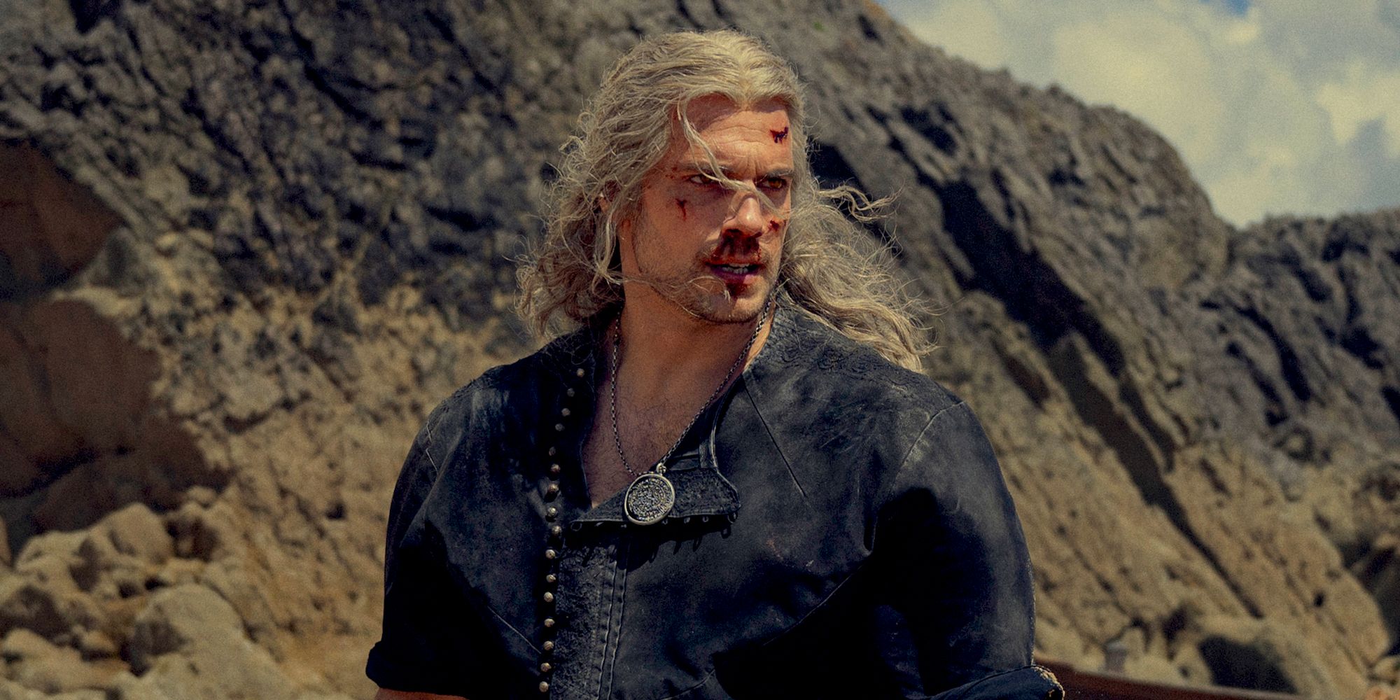 Henry Cavill as a bloodied Geralt with hair in his face in The Witcher season 3, part 2.