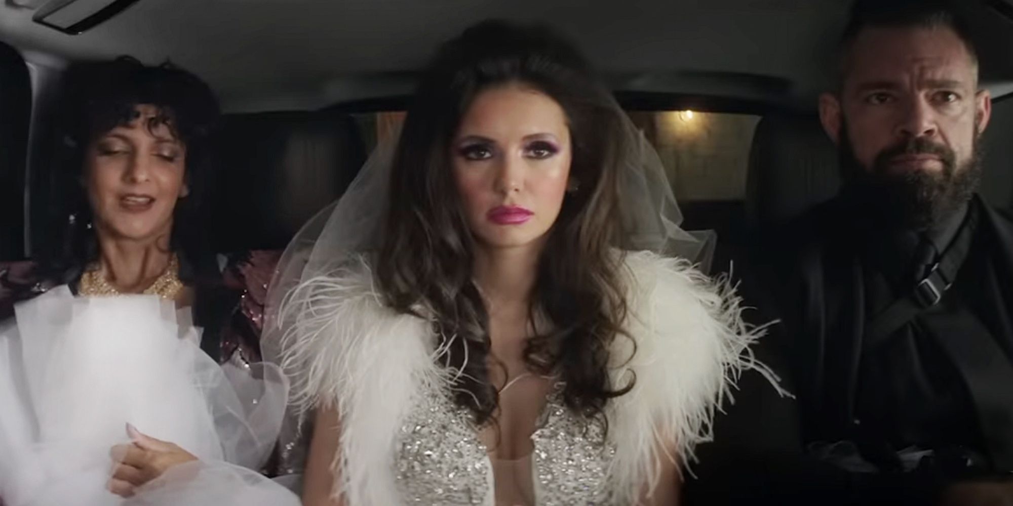 The Out-Laws: Parker in a wedding dress being held hostage by Rehan and her henchmen, sitting in a car
