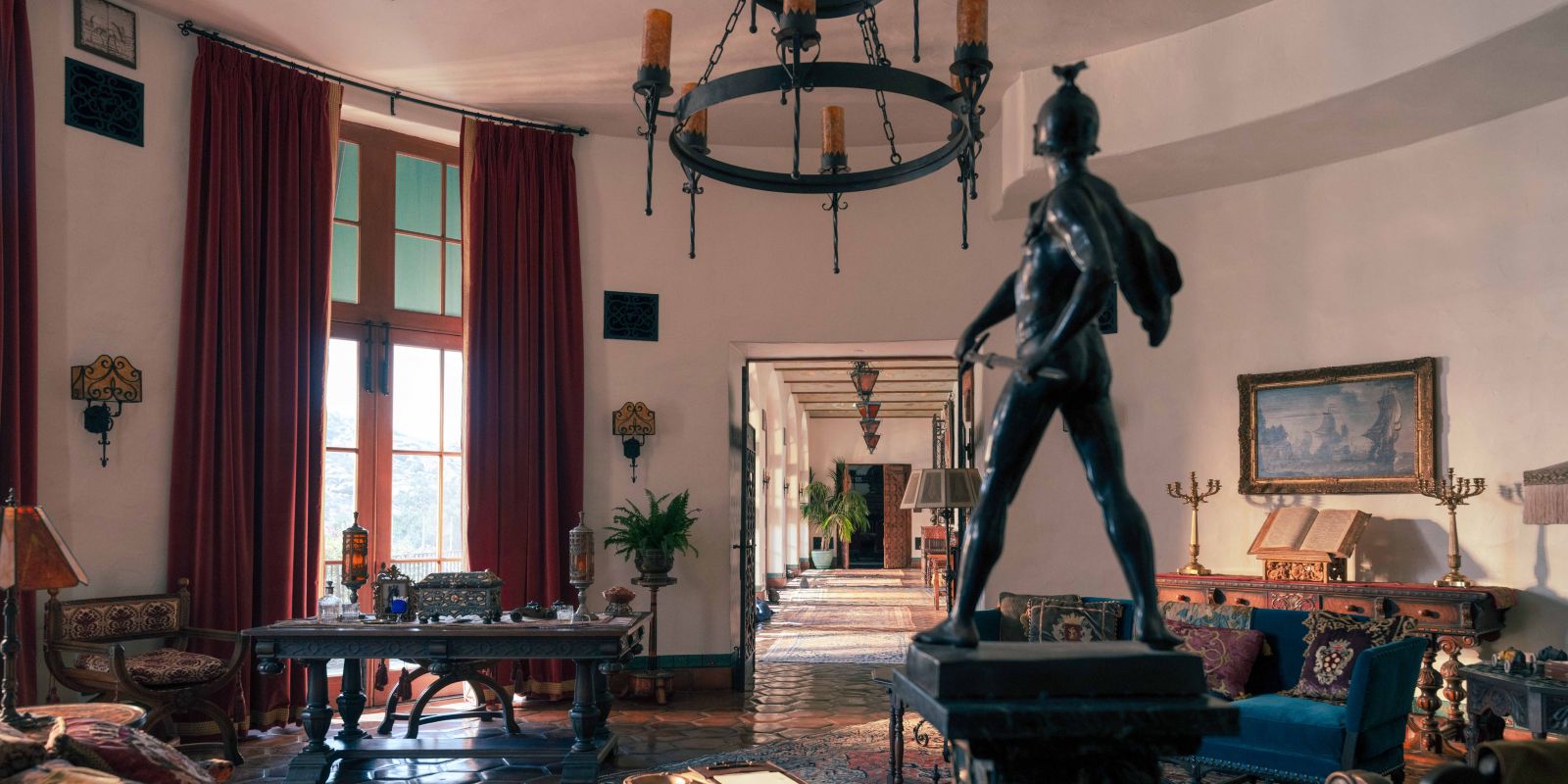 This image shows Jack Conrad&rsquo;s mansion with opulent statues and furniture.