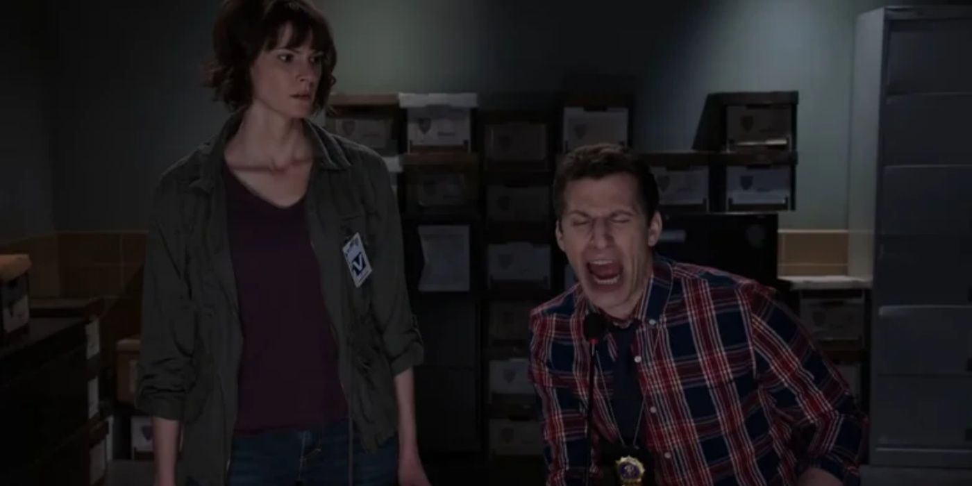 Jake singing on Brooklyn 99 while a witness watches him