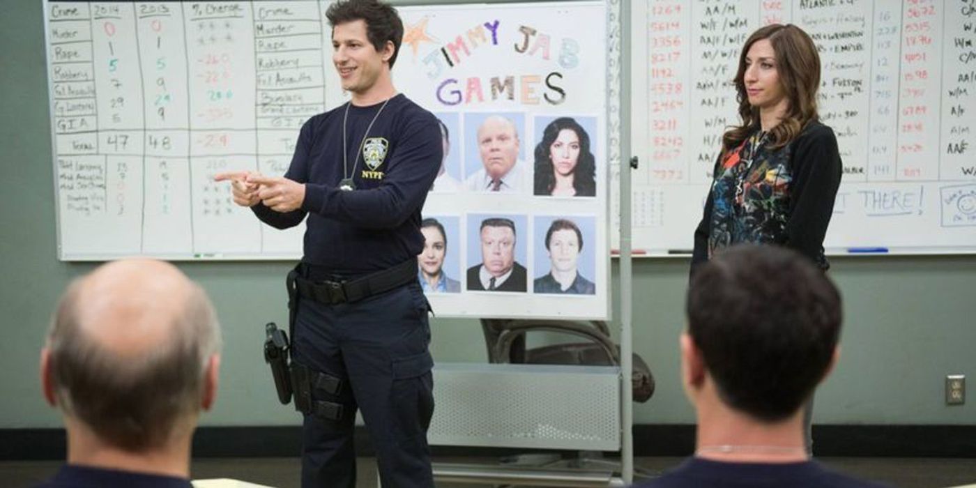 Jake talking to the officers next to Gina in Brooklyn 99