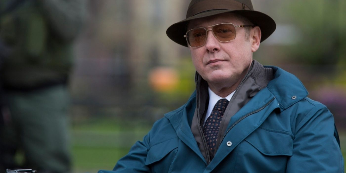 James Spader wearing a fedora and sunglasses sitting down in The Blacklist.