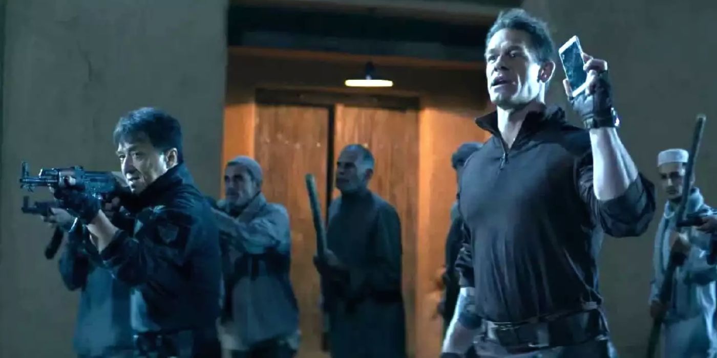 John Cena holding up a phone while Jackie Chan points a gun in Hidden Strike