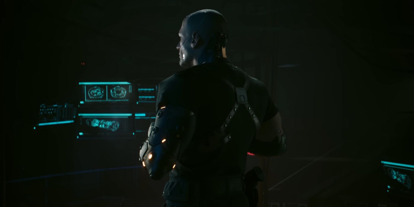 Kurt Hansen in Cyberpunk 2077 Phantom Liberty, facing away from the camera in a dark room.