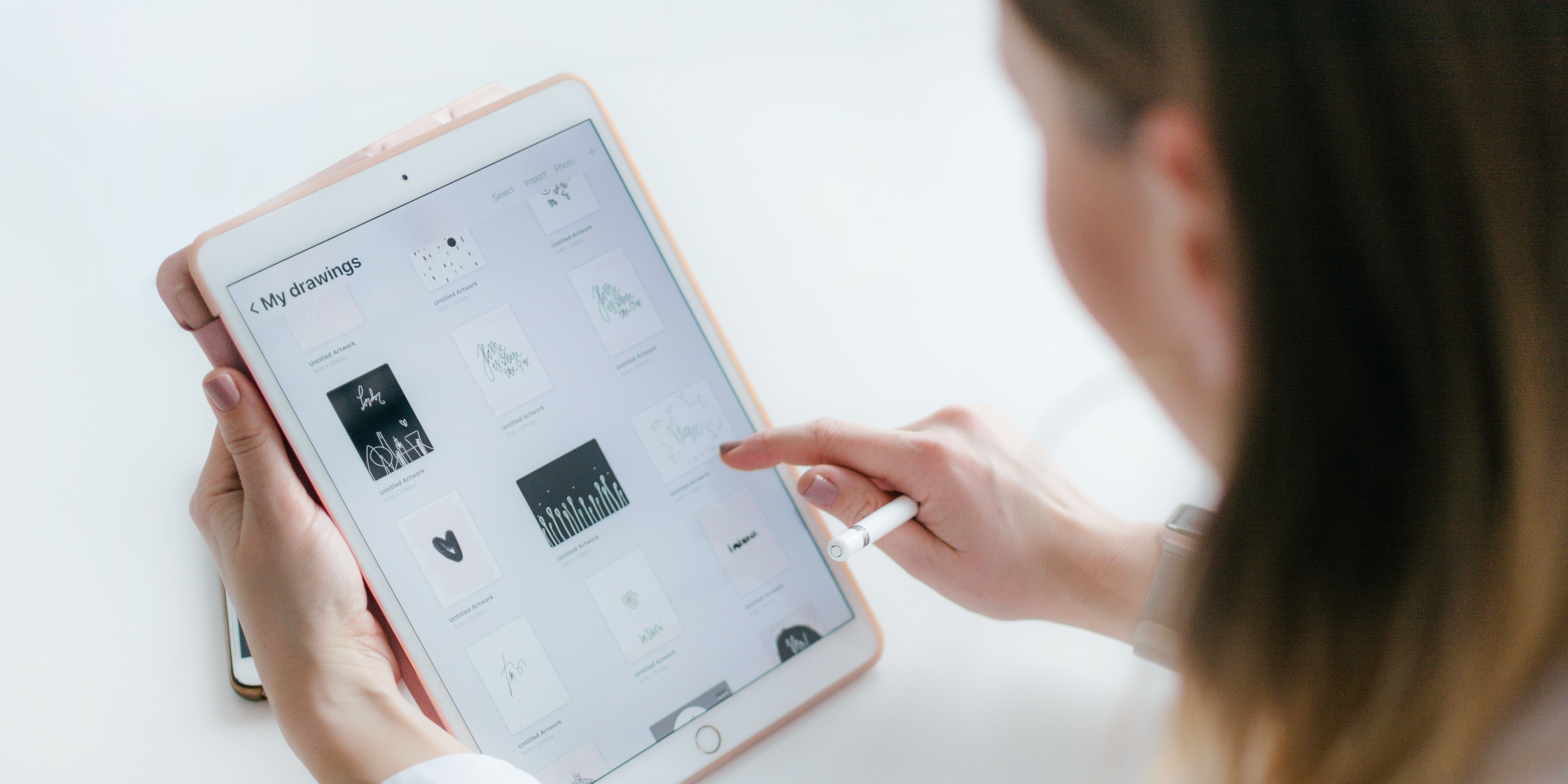Girl holds and looks at tablet