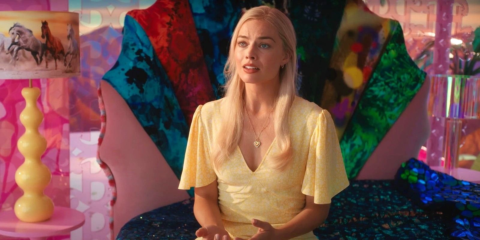 Margot Robbie sitting on a bed near the end of Barbie