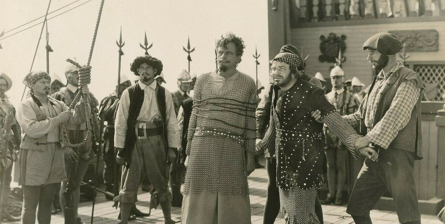 Men held by pirates on the deck of a ship in The Sea Hawk silent movie of 1924