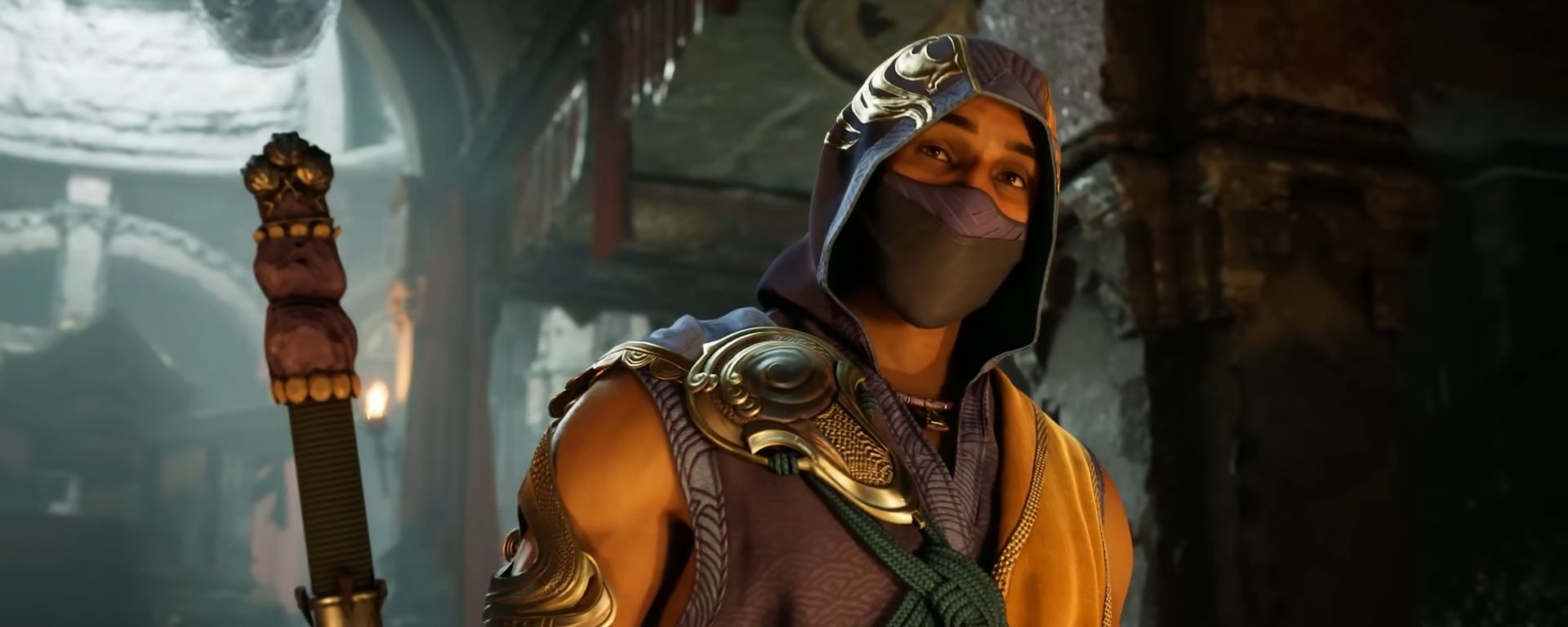 Rain carries a staff and wears a hood and mask in a Mortal Kombat 1 cutscene.