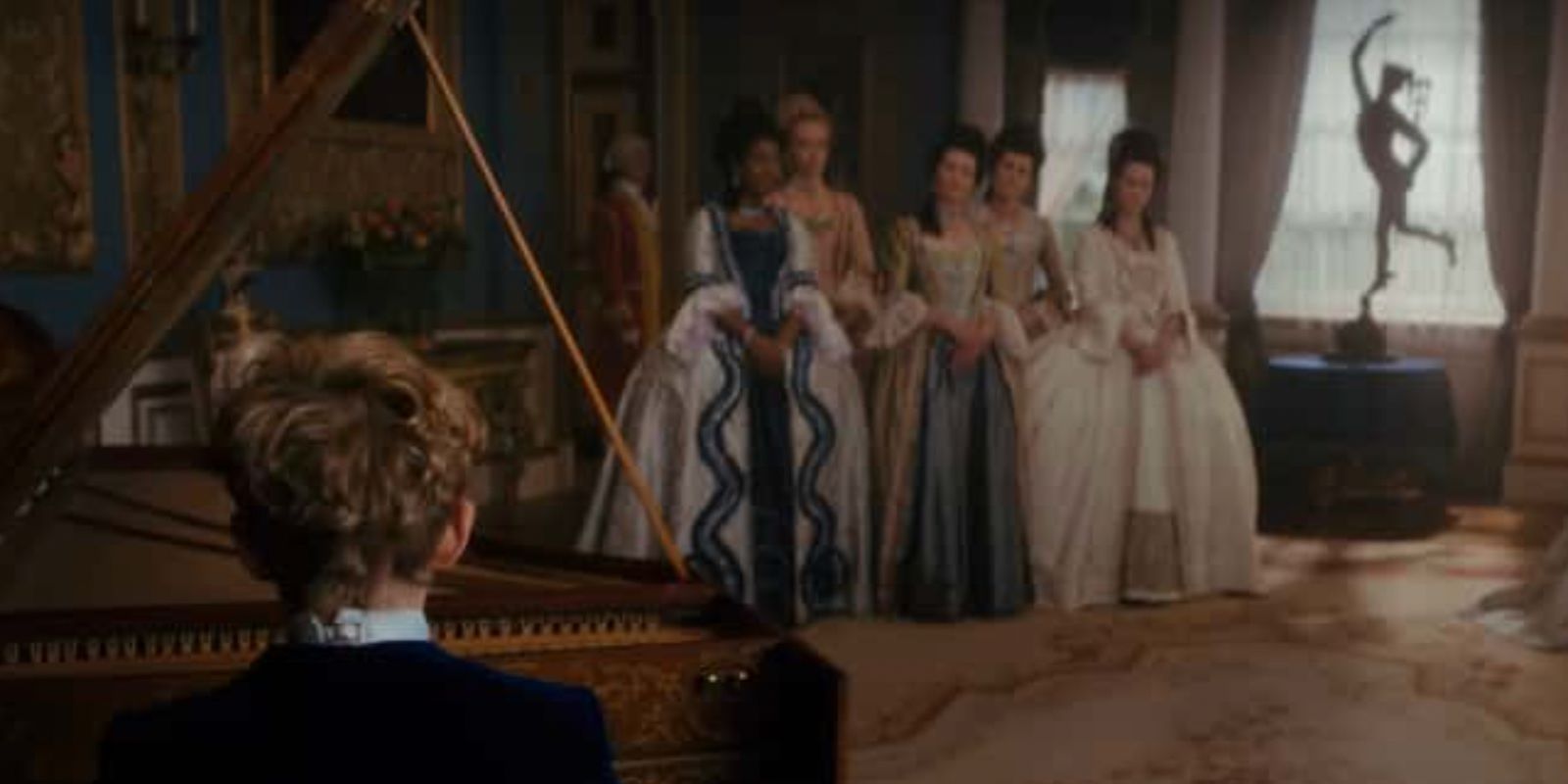 Mozart playing piano for the ladies in waiting in Queen Charlotte A Bridgerton Story