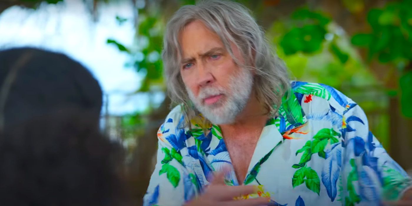 Nicolas Cage with a scruffy white beard and long, stringy white hair wearing a Hawaiian shirt in The Retirement Plan