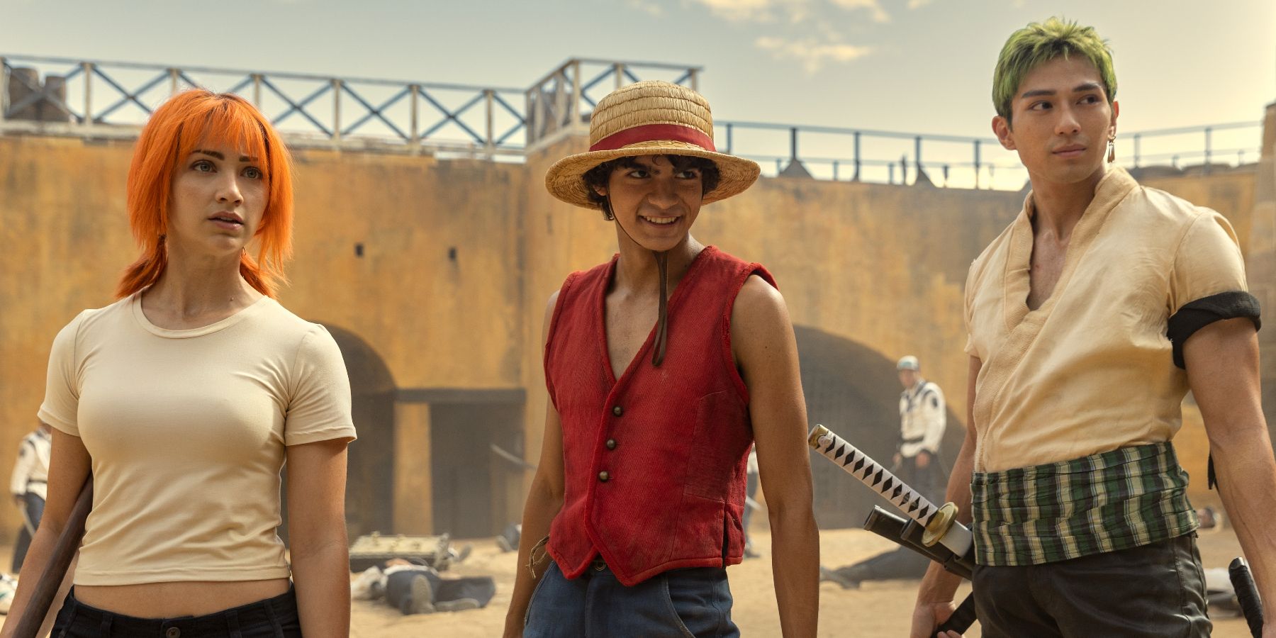  Iñaki Godoy, Emily Rudd, and Mackenyu as Luffy, Nami, and Zoro standing together in One Piece live action