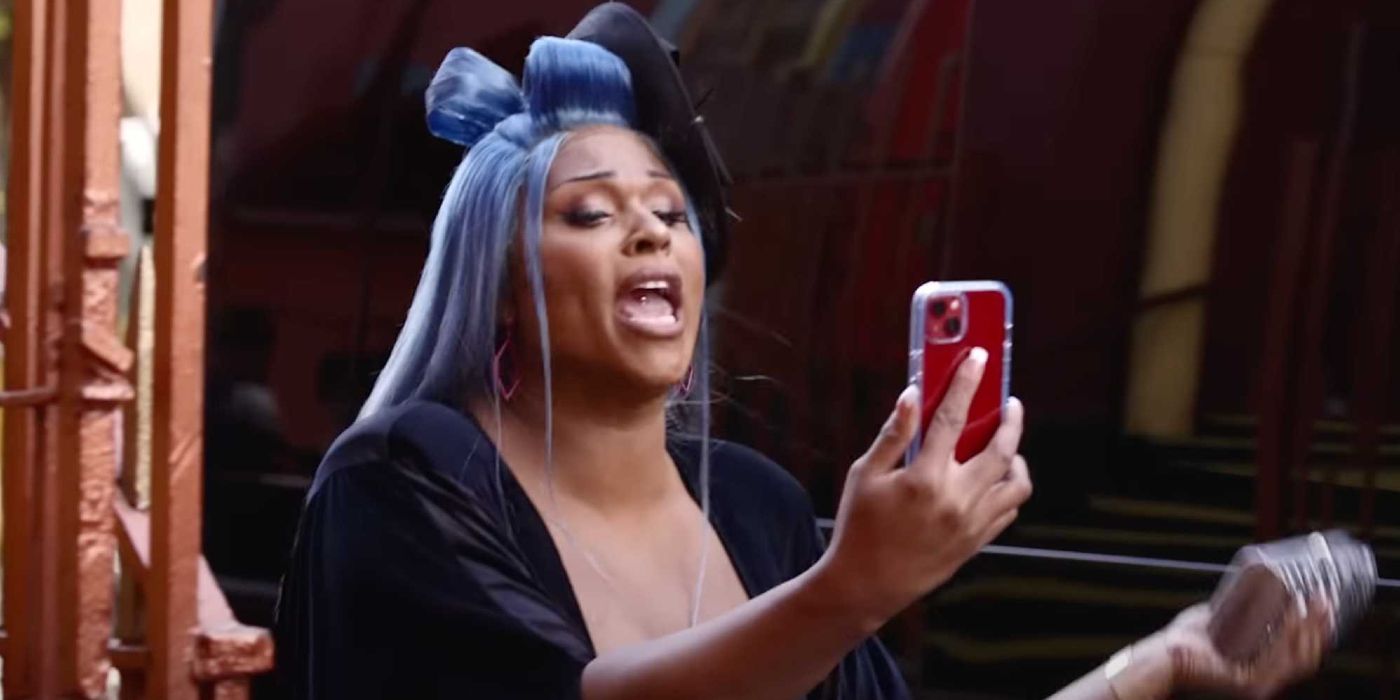 Peppermint uses her phone with curlers in her hair.