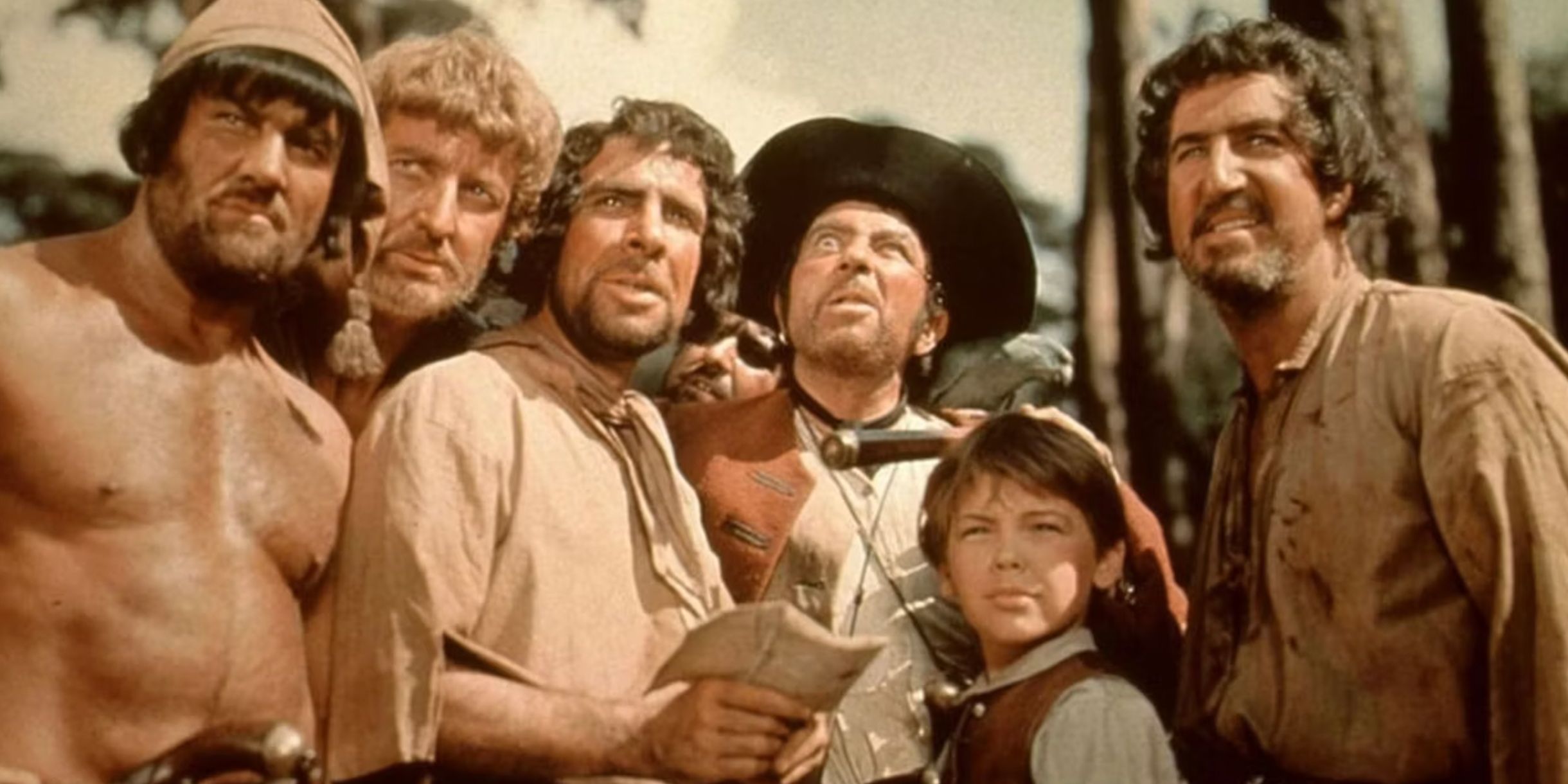 Pirates stand around Jim Hawkins in the 1950 version of Treasure Island