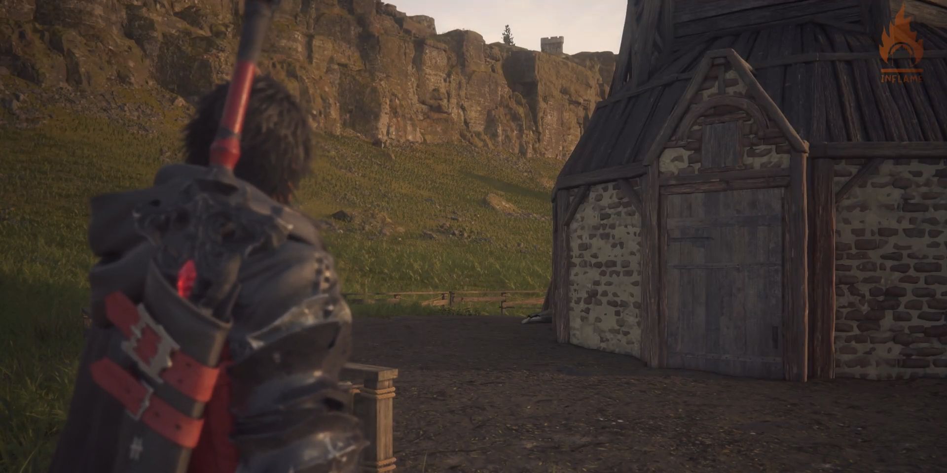 Clive, his back turned, looks at a space behind a distant windmill in a screenshot from Final Fantasy 16. A person&rsquo;s legs, lying on the ground, are just barely visible behind the windmill.