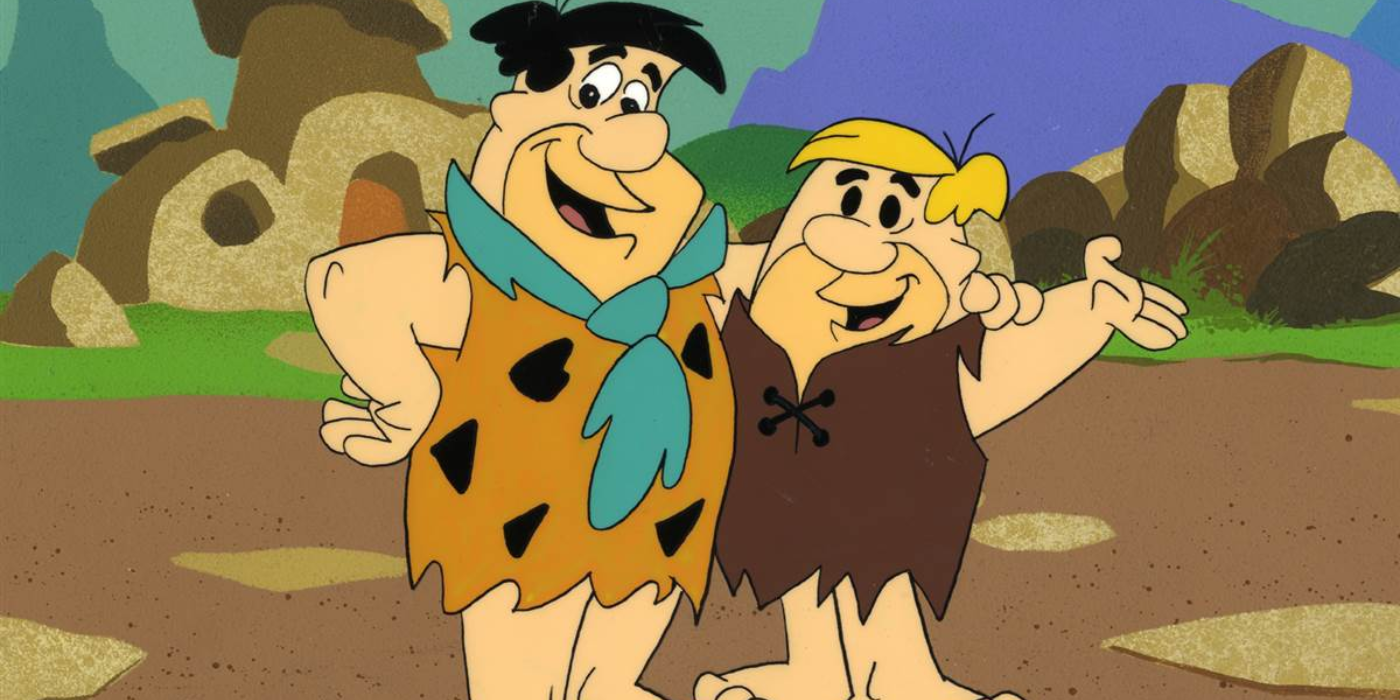 Retrato de Fred e Barney sorrindo com a StoneAge atrás deles