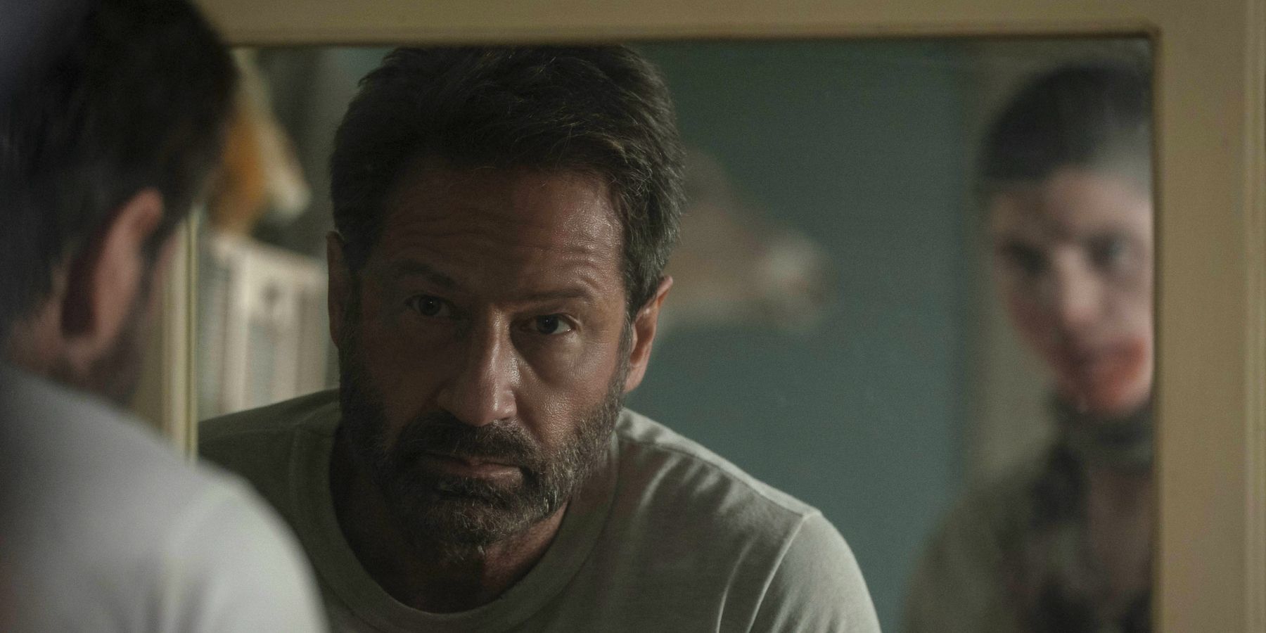 David Duchovny looking looking in mirror as someone sneaks up behind them in Pet Sematary Bloodlines