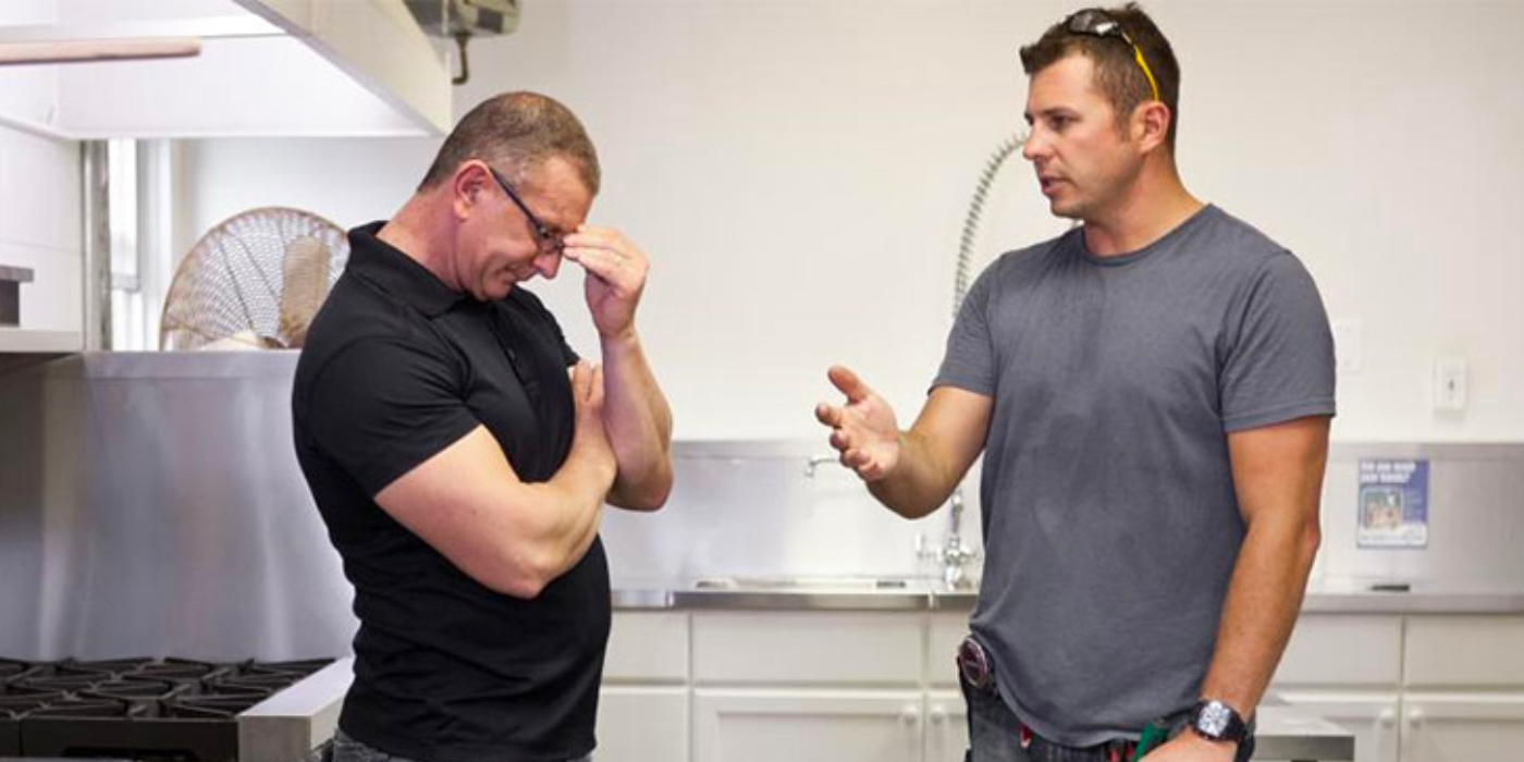 Restaurant Impossible host Robert Irvine, with his hand on his forehead