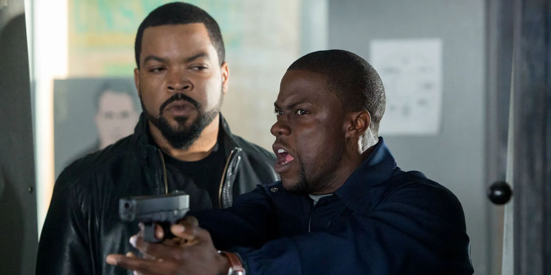 Ice Cube looking at Kevin Hart holding a gun in Ride Along