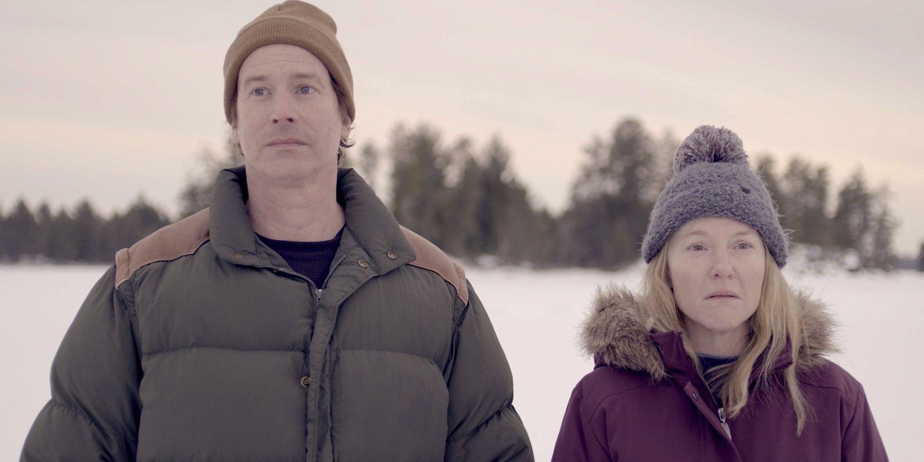 Rob Huebel and Rachel Harris standing outside in the snow in International Falls