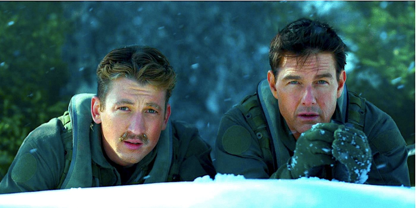 Rooster (Miles Teller) and Maverick (Tom Cruise) spy in the snow in Top Gun Maverick